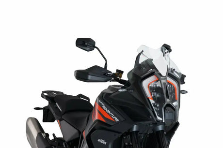 Black and orange adventure motorcycle with sport windscreen and prominent headlight