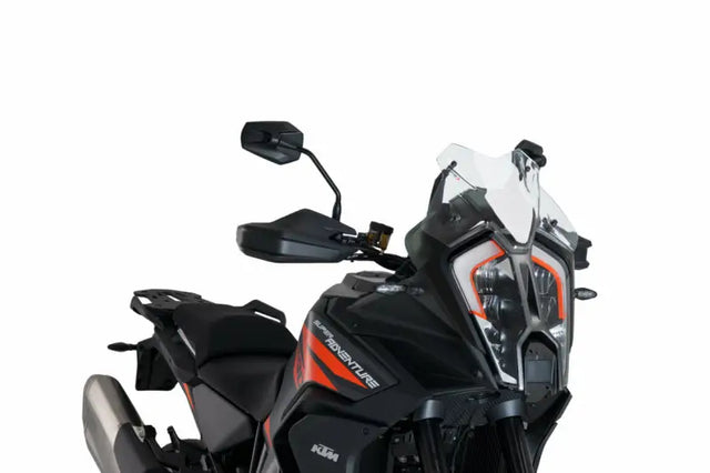 Black and orange adventure motorcycle with sport windscreen and prominent headlight