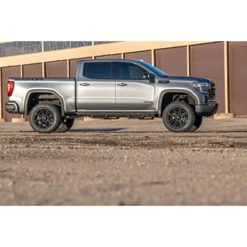 Side view of a silver truck equipped with the 44-3965 Readylift 6'' Big Lift Kit with Rear Bilstein, showcasing an enhanced stance, larger tires, and superior suspension for off-road and on-road performance, RV, Automotive, Powersports, off-road, marine, exterior, truck accessories, interior, truck bed, rv parts, Suspension, AVADA - Best Sellers, Must Haves