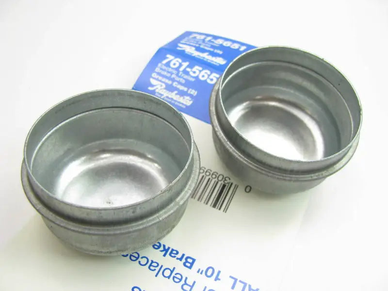 Two metal grease caps for electric trailer brakes on Raybestos Electric Trailer Brakes system