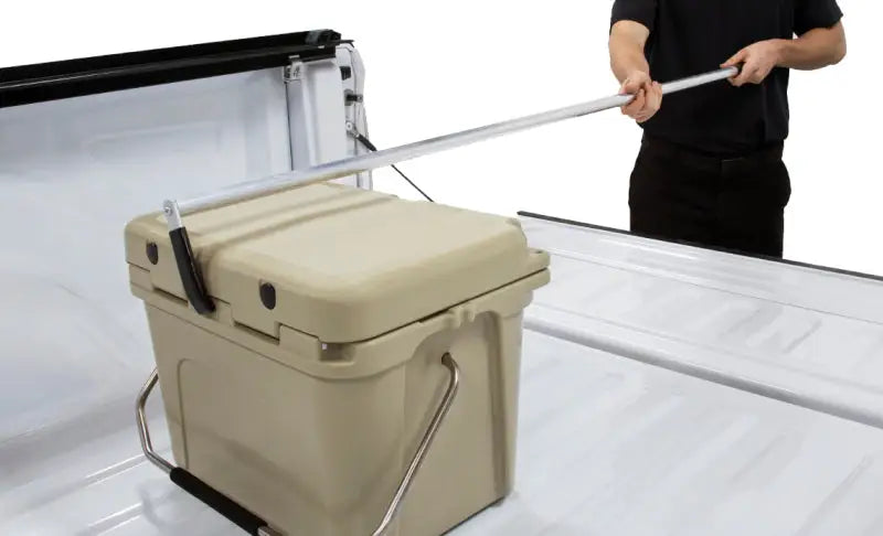 Tan cooler with metal handles for truck bed cargo reaching tool by Access Accessories