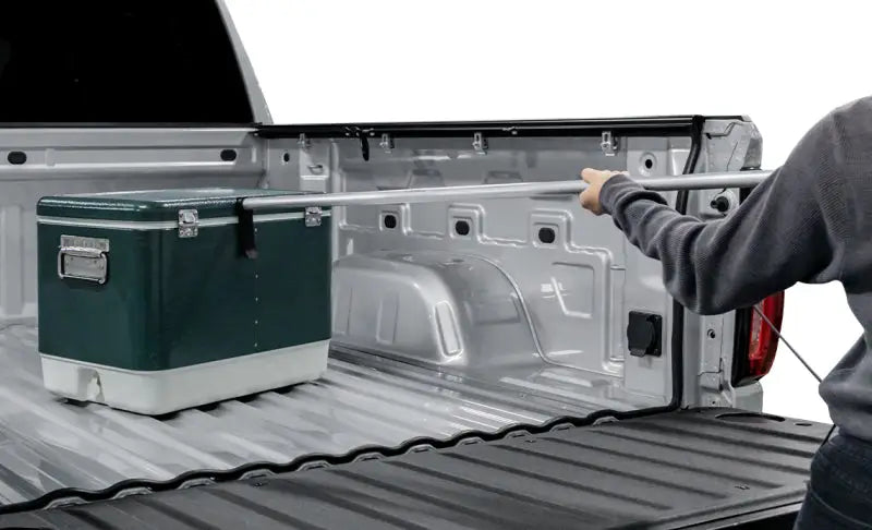 Green and white cooler in truck bed with Access Accessories EZ-Retriever II cargo reaching tool