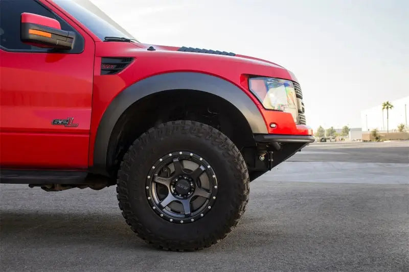 Red Ford Raptor truck with Addictive Desert Designs ADD PRO front bumper