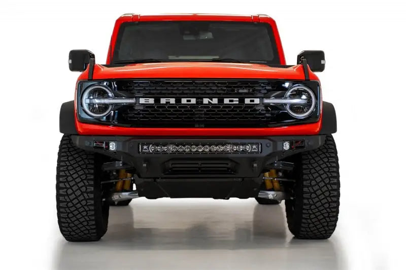 Addictive Desert Designs Stealth Fighter Front Bumper with Winch Mount on a 2021+ Ford Bronco, featuring a 30" light bar.