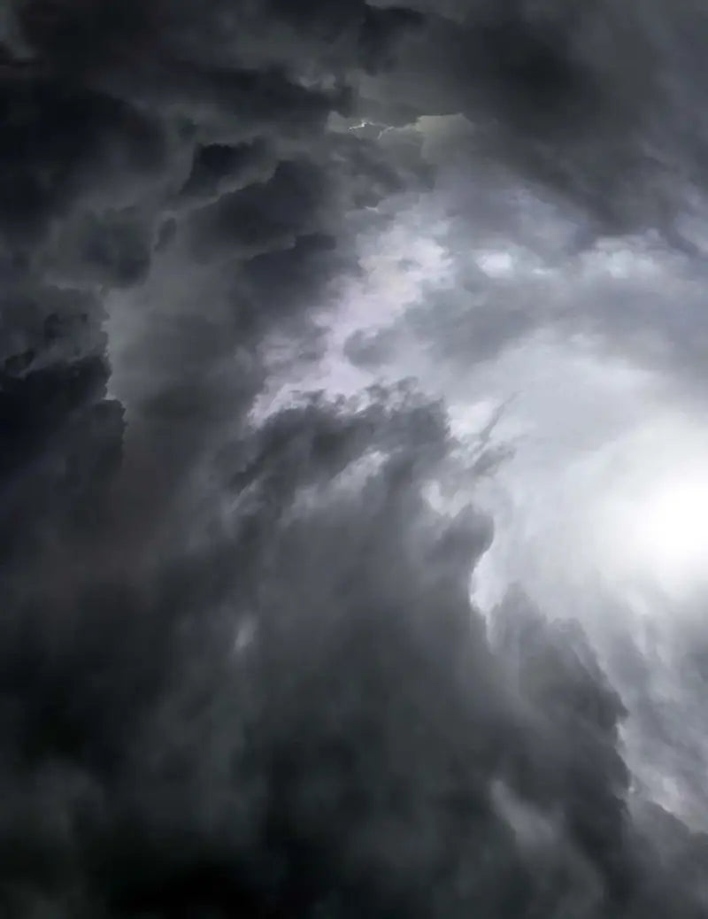 Ominous storm clouds behind Answer 23 Aerlite Glove midnight blue white youth small