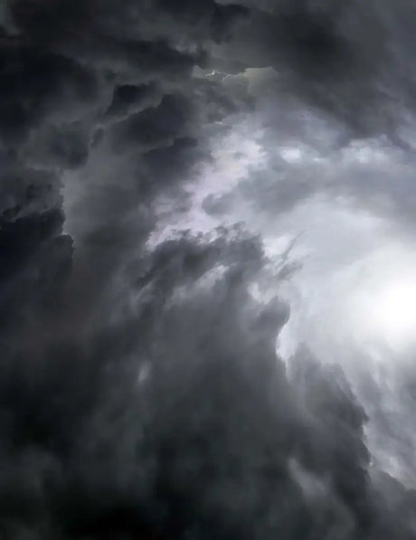 Ominous storm clouds behind Answer 23 Aerlite Glove Midnight Blue White Youth Small