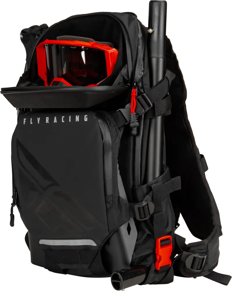 Black Backcountry Pack with shoulder straps, red goggles, and truck parts accessory