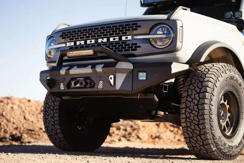 DV8 Offroad MTO Series front bumper on a 2021 Ford Bronco, featuring winch capability, optional bull bar, and auxiliary light openings.