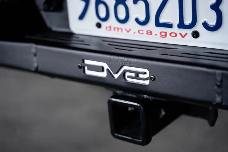 DV8 Offroad 21-23 Ford F-150 MTO Series Rear Bumper with license plate in view, showcasing steel construction and utility features.