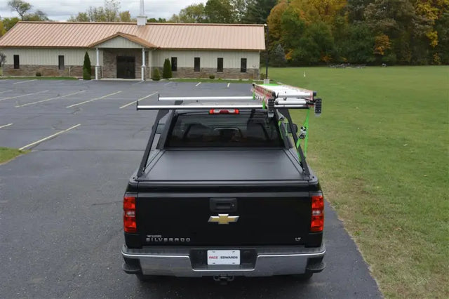 Black pickup truck with roof rack.