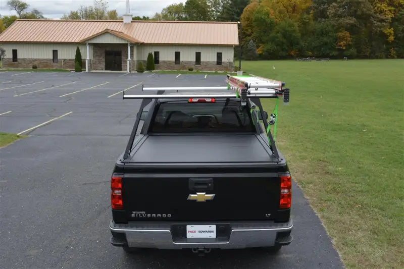 Black Chevy Silverado with ELF0103 Pace Edwards El400 Series Medium Duty Elevated R tonneau cover, featuring durable construction and elevated design for easy cargo access. Ideal for truck bed, RV, automotive, powersports, off-road, marine exterior, and truck accessories. Enhances sleek appearance and security, RV Steps and Ladders, AVADA - Best Sellers, Must Haves.
