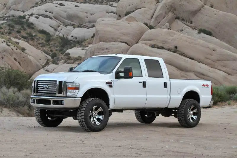 White Ford F250 Super Duty pickup with Fabtech 4in Budget System and 8 Lug wheels