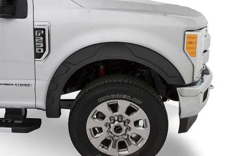 Close-up of a Ford F150 equipped with the FF18-K4560-1 Fab Fours 18 Fd F150 Rnch Fgg, highlighting the vehicle's enhanced rugged front end and Michelin tire.