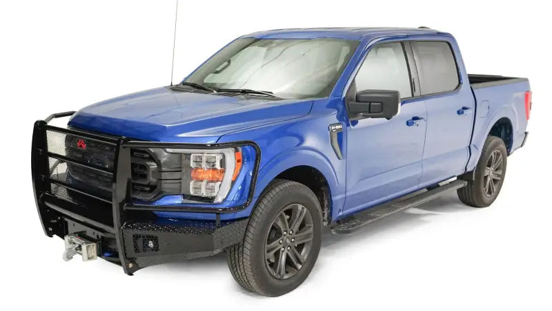 FF21-K5060-1 Fab Fours Elite Series Front Bumper on a blue Ford F-150, showcasing rugged design, high-quality construction, and integrated winch mount for off-road functionality.