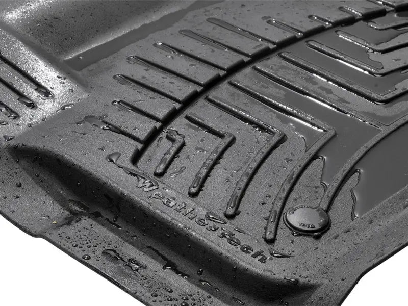 WeatherTech black floor liner, molded fit with channels and reservoir, thermoplastic polyolefin (TPO) material.