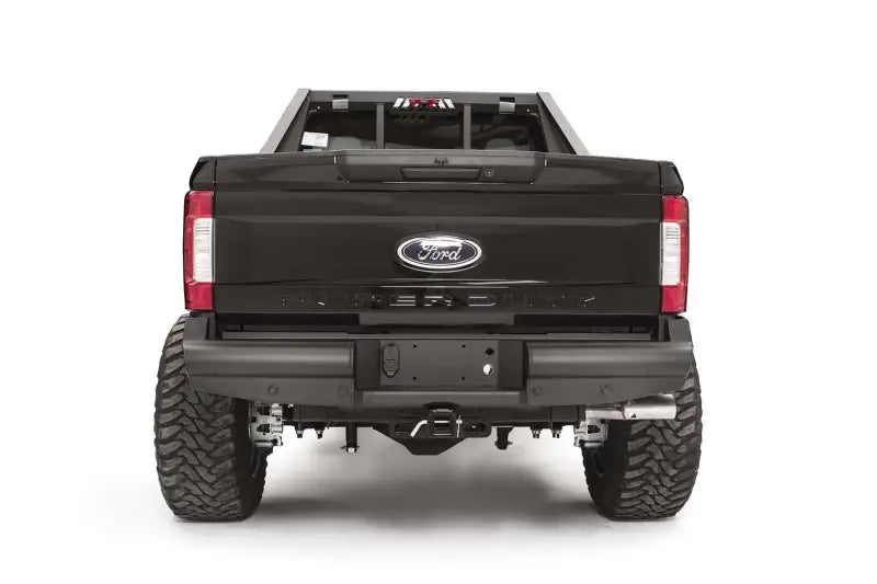 Rear view of a Ford F250/F350 featuring the Fab Fours FS17-U4150-1 Elite Rear bumper, emphasizing its sleek and durable design.