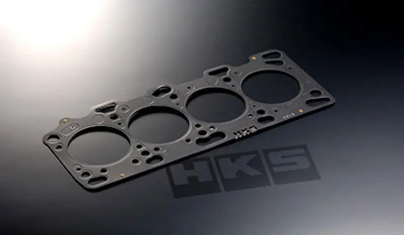 Black metal head gasket with circular openings for Toyota Supra Turbo engine performance