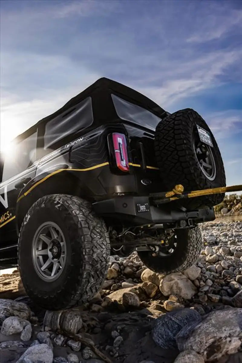 Black off-road vehicle with spare tire showcasing ICON 2021+ Ford Bronco Pro Series rear bumper