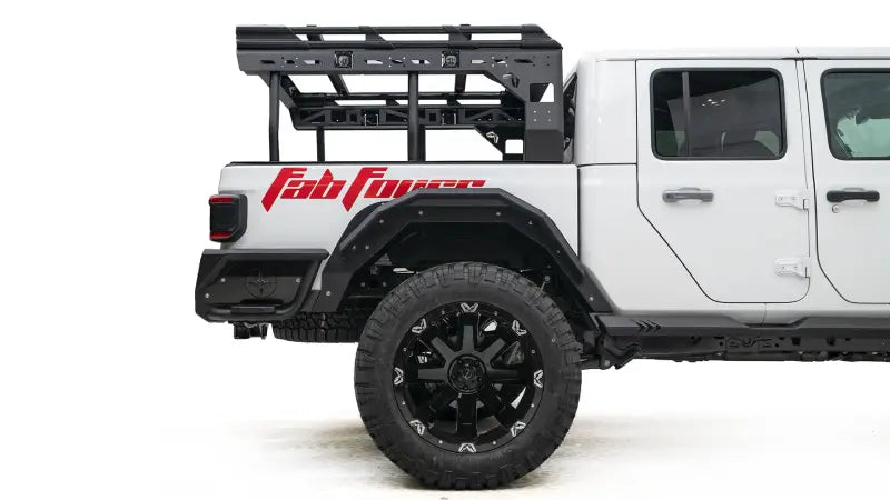 JT1001-1 Fab Fours Gladiator Rear Fender on a white Gladiator, showcasing high-quality construction and bold design with Fab Fours branding.