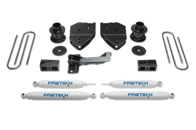 K2213 Fabtech Lift Kit Suspension components for vehicle upgrade, including shock absorbers, mounting brackets, U-bolts, and additional hardware for enhanced off-road performance and larger tire fitment.
