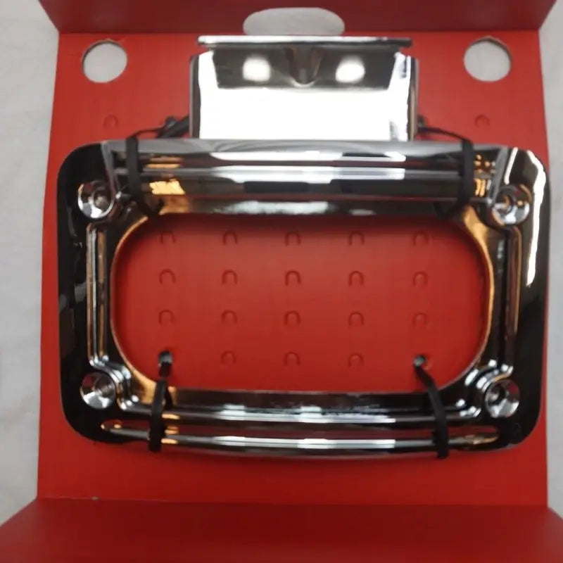 Shiny chrome handle on Kuryakyn L.E.D. Curved License Plate Frame Indian Chrome