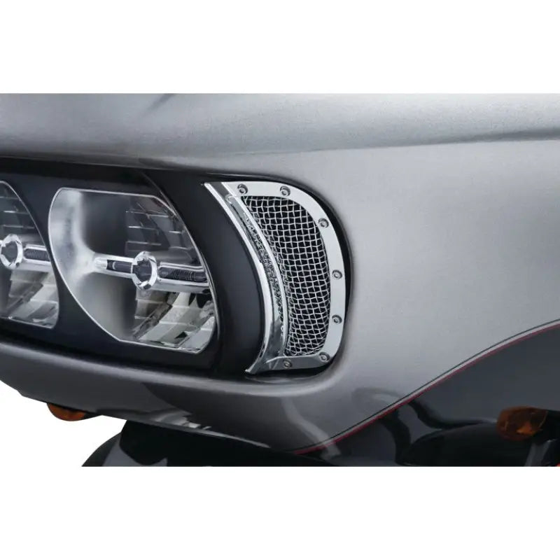 Motorcycle headlight with chrome grill showing Kuryakyn Mesh Headlight Vent Accents