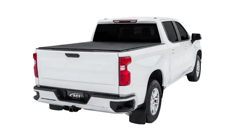 White pickup truck with black tonneau cover showcasing Lomax Stance Hard Cover for F-150