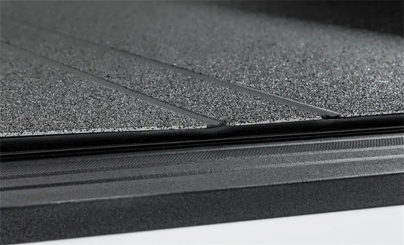 Textured black stance hard cover with parallel grooves for Lomax Stance Hard Cover 19+ Ram 2500/3500
