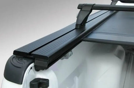 Black plastic Pace Edwards Jackrabbit Rail with steps and rubber grip for truck bed access