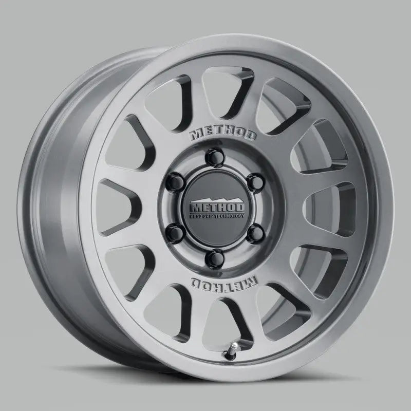 Silver gloss titanium Method MR703 15x7 wheel with multi-spoke design and black center cap