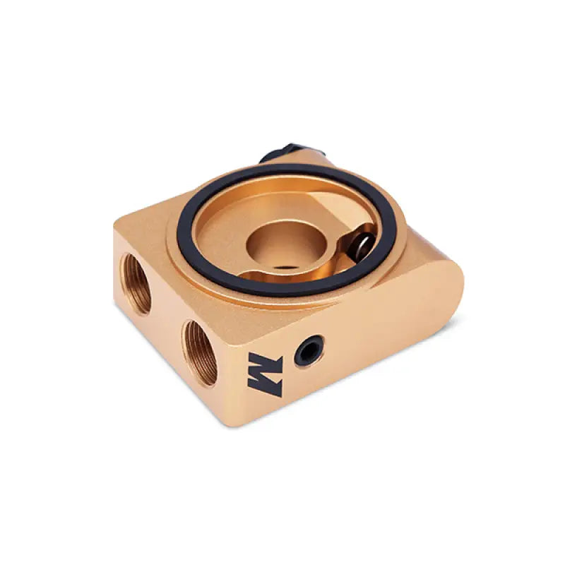 Gold-colored oil filter adapter for Mishimoto oil cooler kit on Ford Fiesta ST