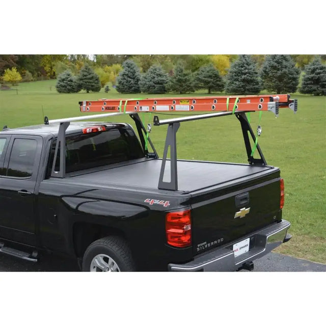 Black pickup truck with ladder rack.