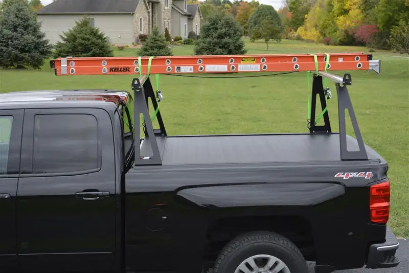 Black pickup truck with ladder rack.