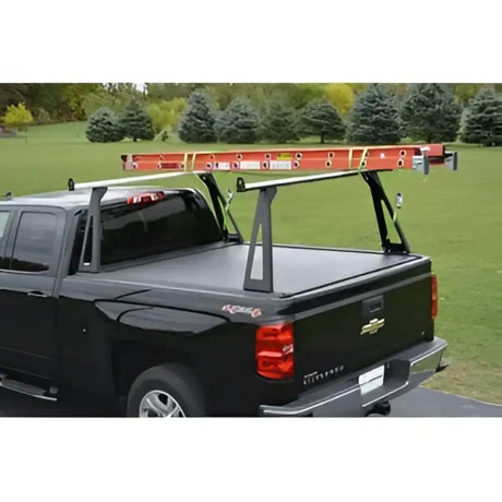 Black pickup truck with ladder rack.