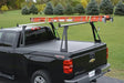 Black pickup truck with ladder rack.