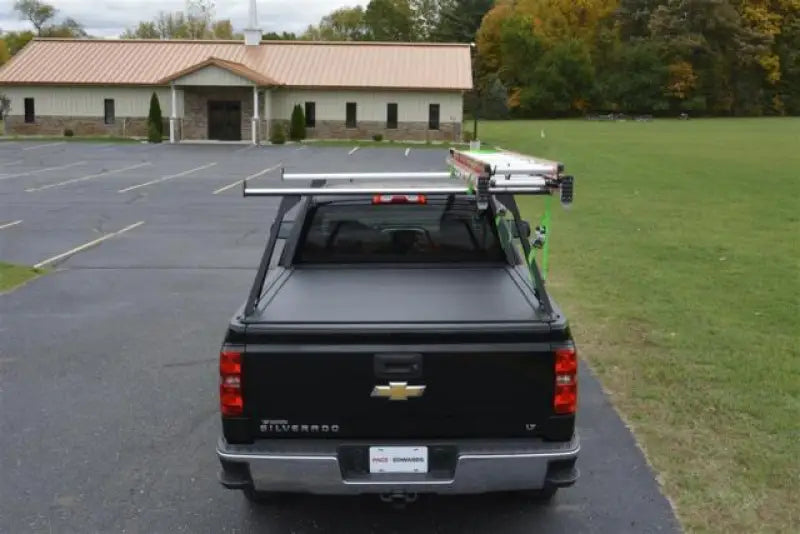 Black pickup truck with ladder rack.