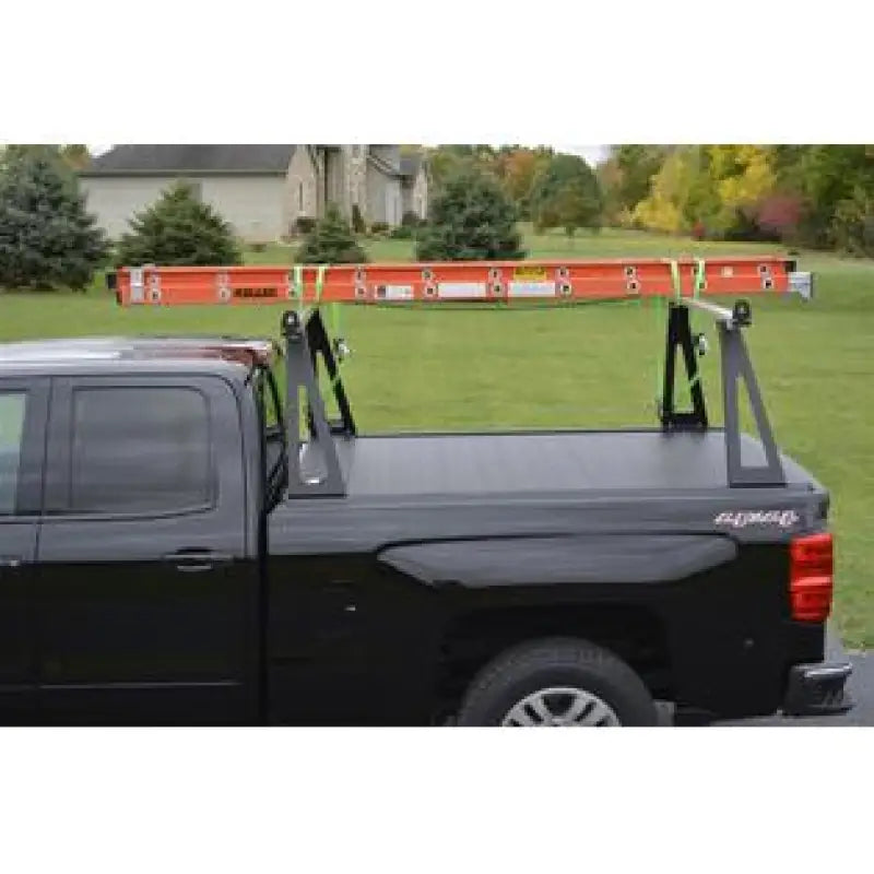 Black pickup truck with ladder rack.
