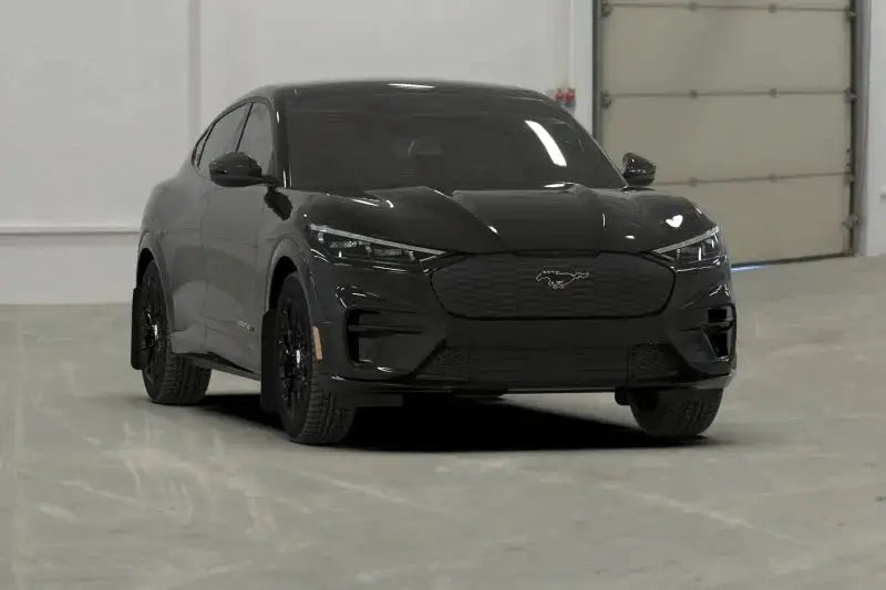 All-black Ford Mustang Mach-E electric SUV with metallic black logo mud flaps