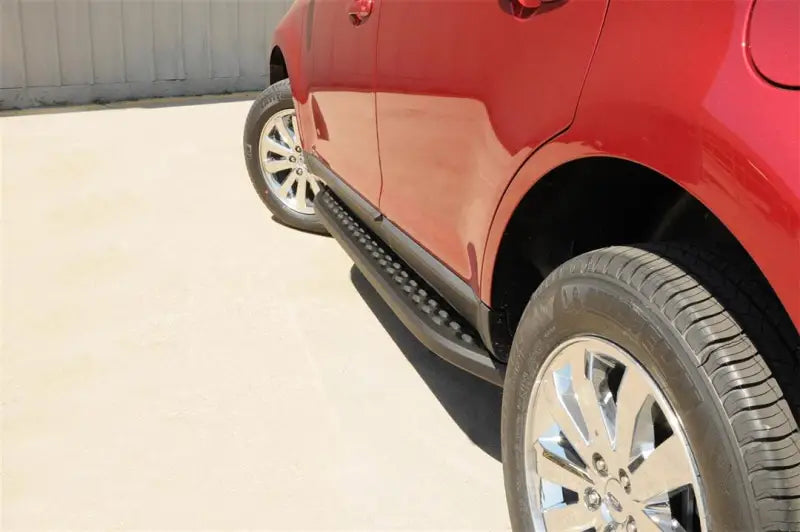 Red SUV with powder coated running board with black trim and stainless steel finish