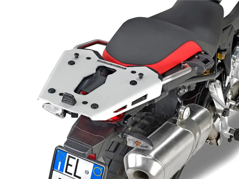 Silver motorcycle luggage rack with mounting hardware and black red seat for BMW