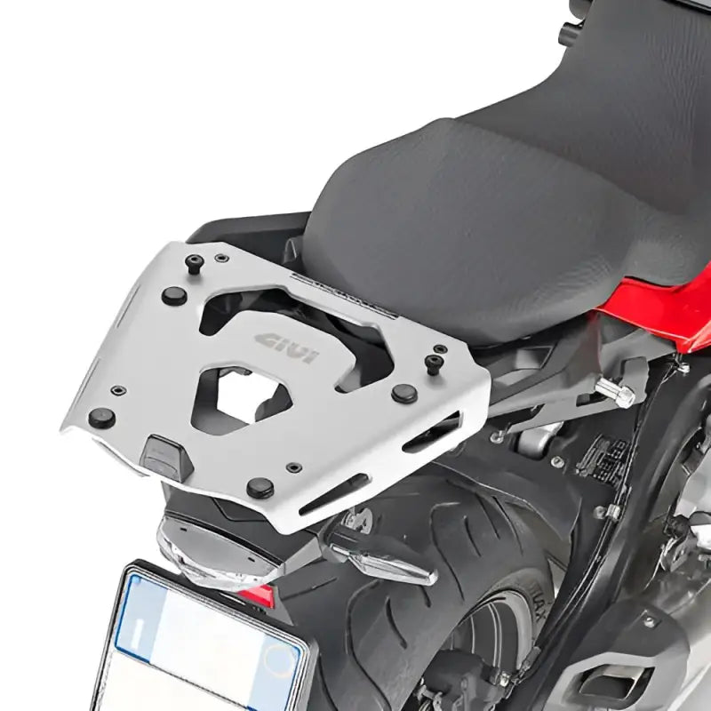 Silver motorcycle luggage rack mounted on the rear with mounting hardware for BMW R1200GS