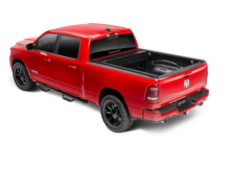 Red pickup truck with black matte Tonneau Cover Manual Retractable and Trax Rail System