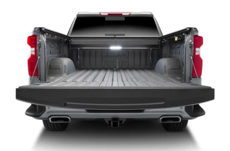 Open pickup truck bed with Tonneau Cover Power Retractable in Matte Black