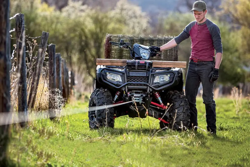 Black ATV with warn industries winch mount on warn industries UTV front bumper