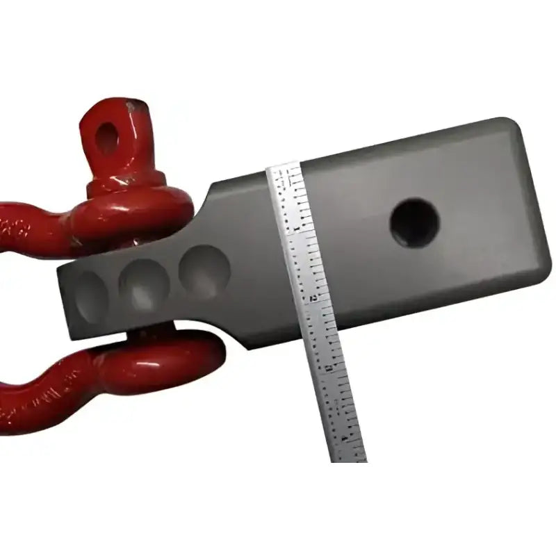 Factor 55 Hitchlink Pro 2.5 for 2.5' receivers showcasing durable construction with a red hitch accessory and measurement tool.
