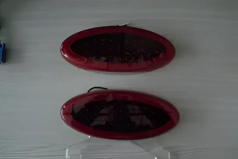 Two oval-shaped 003-85 Creative Pro LED tail lights in red, offering enhanced visibility for stop, tail, and turn signals, designed for RV, automotive, powersports, off-road, marine, exterior, truck accessories, interior, truck bed, and RV parts, RV Lighting, Towing & Hitches, Audio & Electronics, Towing | Trailer | Axles | Brakes | Boat, Lighting - Towing Clearance Lights, AVADA - Best Sellers