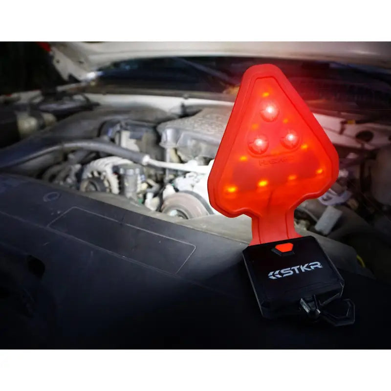 Red triangular hazard safety light from Stkr Concept Flexit Auto Roadside for roadside safety