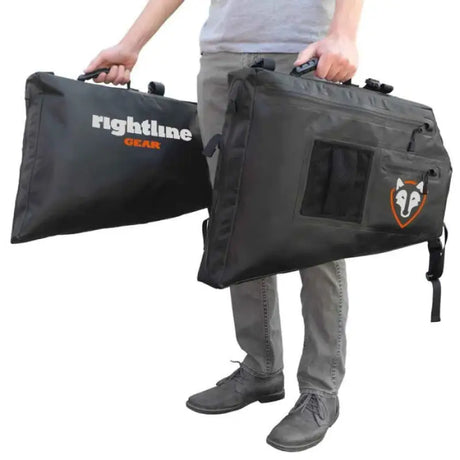 Black storage bags with handles held by a person for 100J75-B Rightline Side Storage Bag