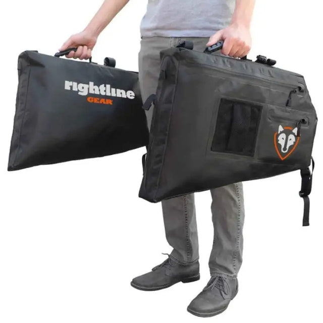 Black storage bags with handles held by a person for 100J75-B Rightline Side Storage Bag