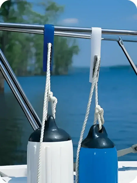 Adjustable fenders hanging on a boat's railing using the 1131 Taylor Made Tidy Gard Fender Adjuster, ensuring easy height adjustments for optimal protection. Marine, AVADA - Best Sellers